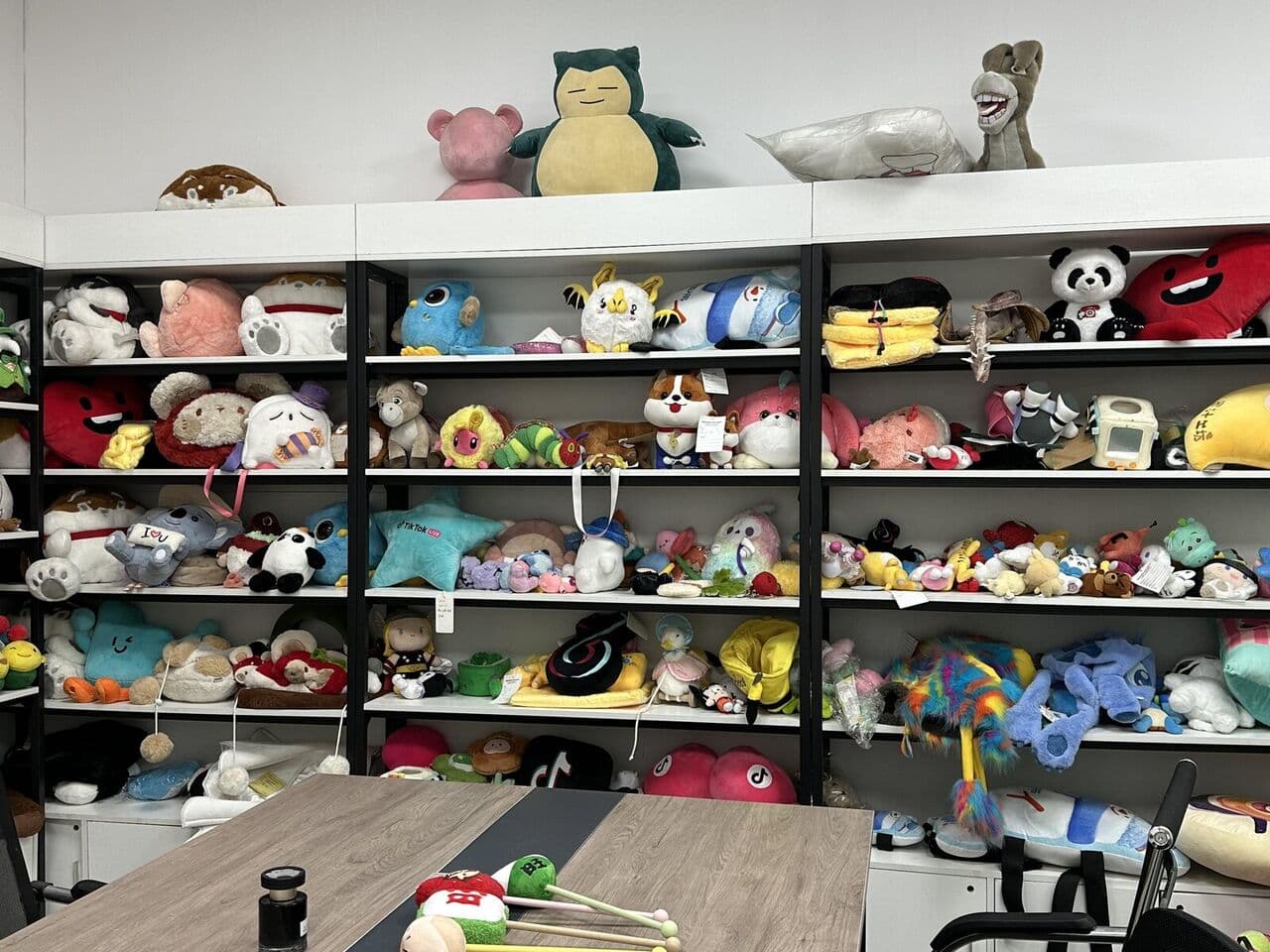 Shelves of custom plush toys at Bella factory